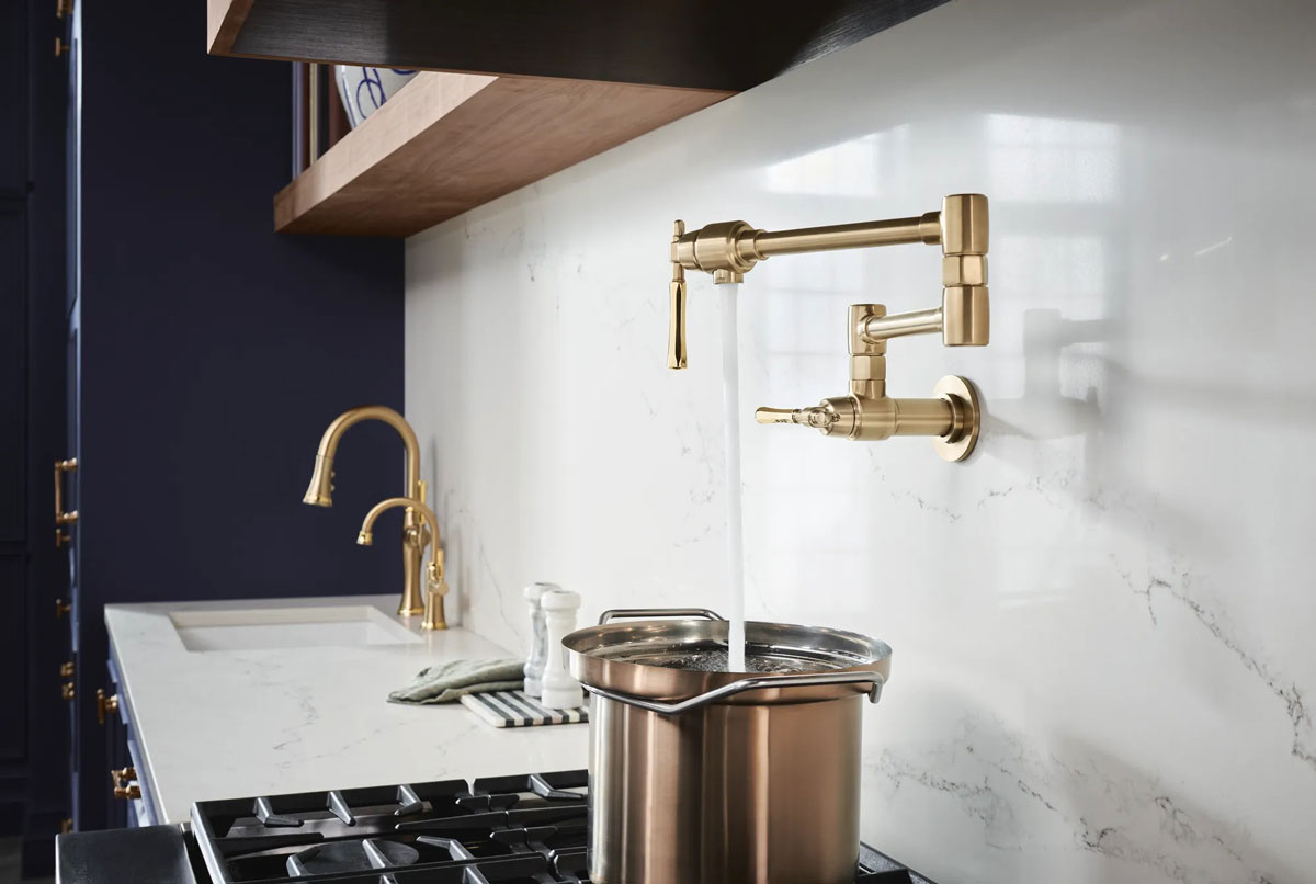water filling pot on stove from pot filler installed in wall